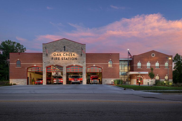 An external view at dusk of a four-bay fire station in Oak Creek