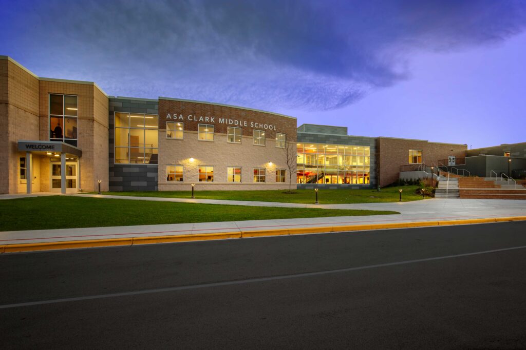 An exterior, twilight view of the updated Asa Clark Middle School