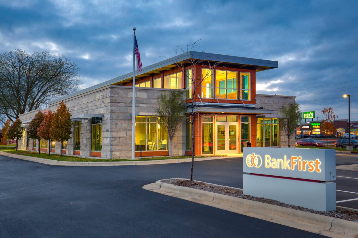 Exterior at dusk of stone-clad bank building