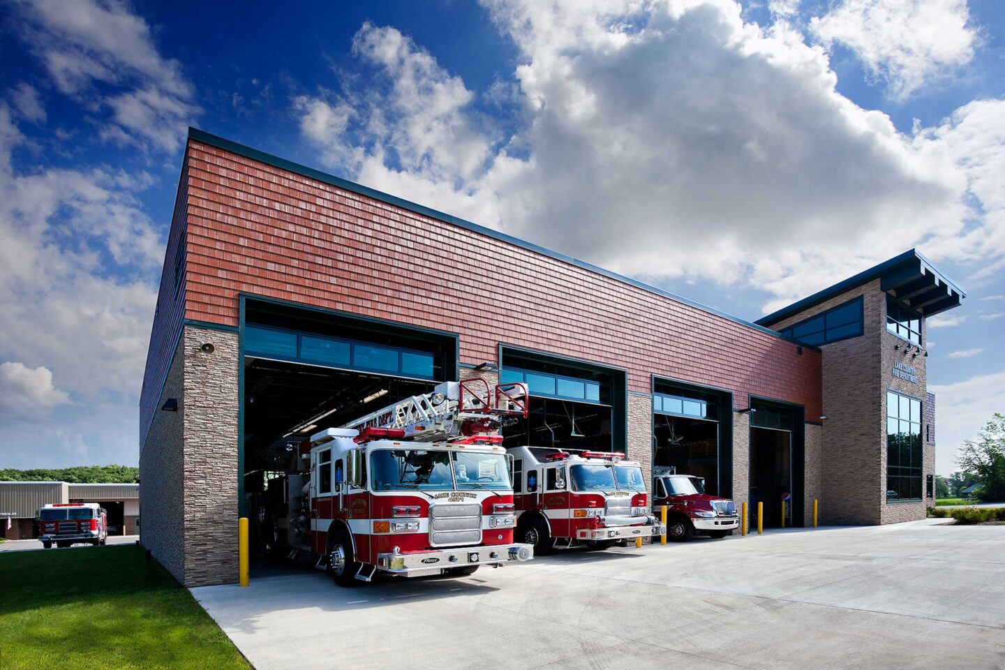 Fire trucks peek out of four bays in a modern public safety building in Delafield
