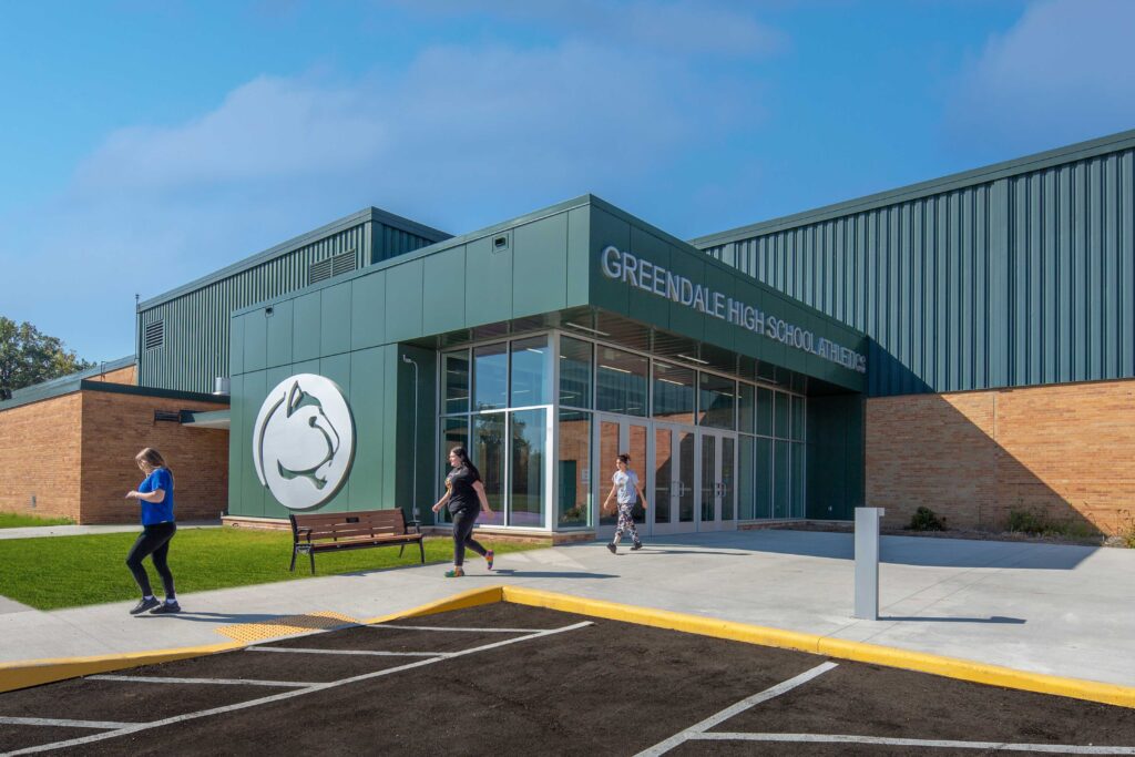 A new athletics entrance accented by school colors and logos connects into the existing high school