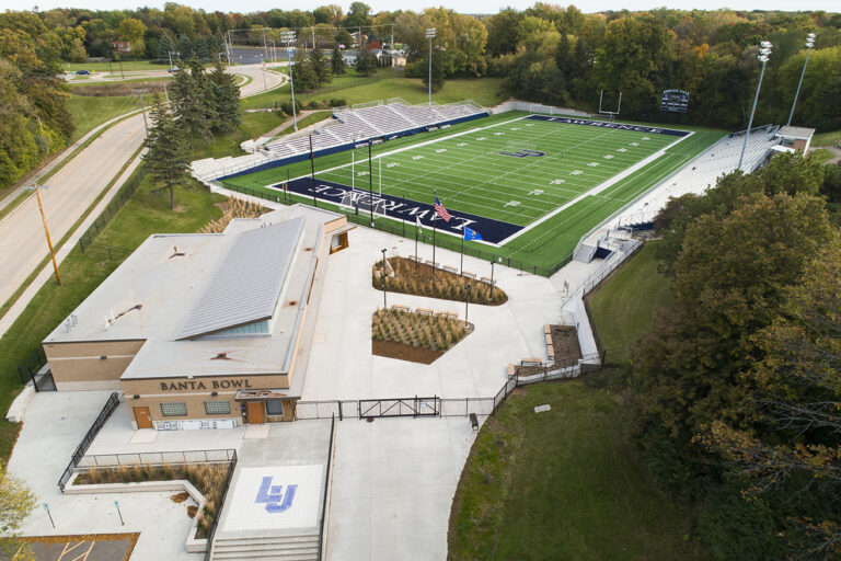 Overhead view of a football field and adjacent plaza and facilities