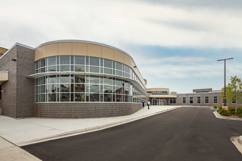 Exterior view of a curved cafeteria addition that mimics the shape of a guitar at Les Paul Middle School