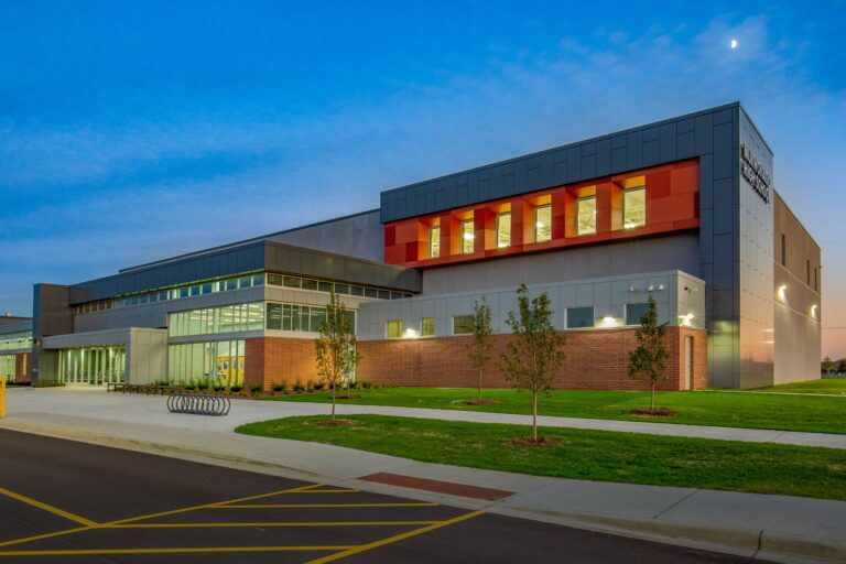 Exterior view at dusk of a modern addition to Mukwonago High School