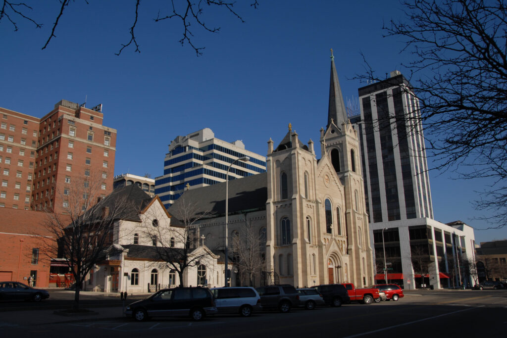 A historic church with a new addition nestles in an urban setting