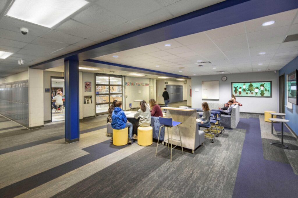 Classrooms and locker areas connect with an open area for students to collaborate and study at Wheatland Center School