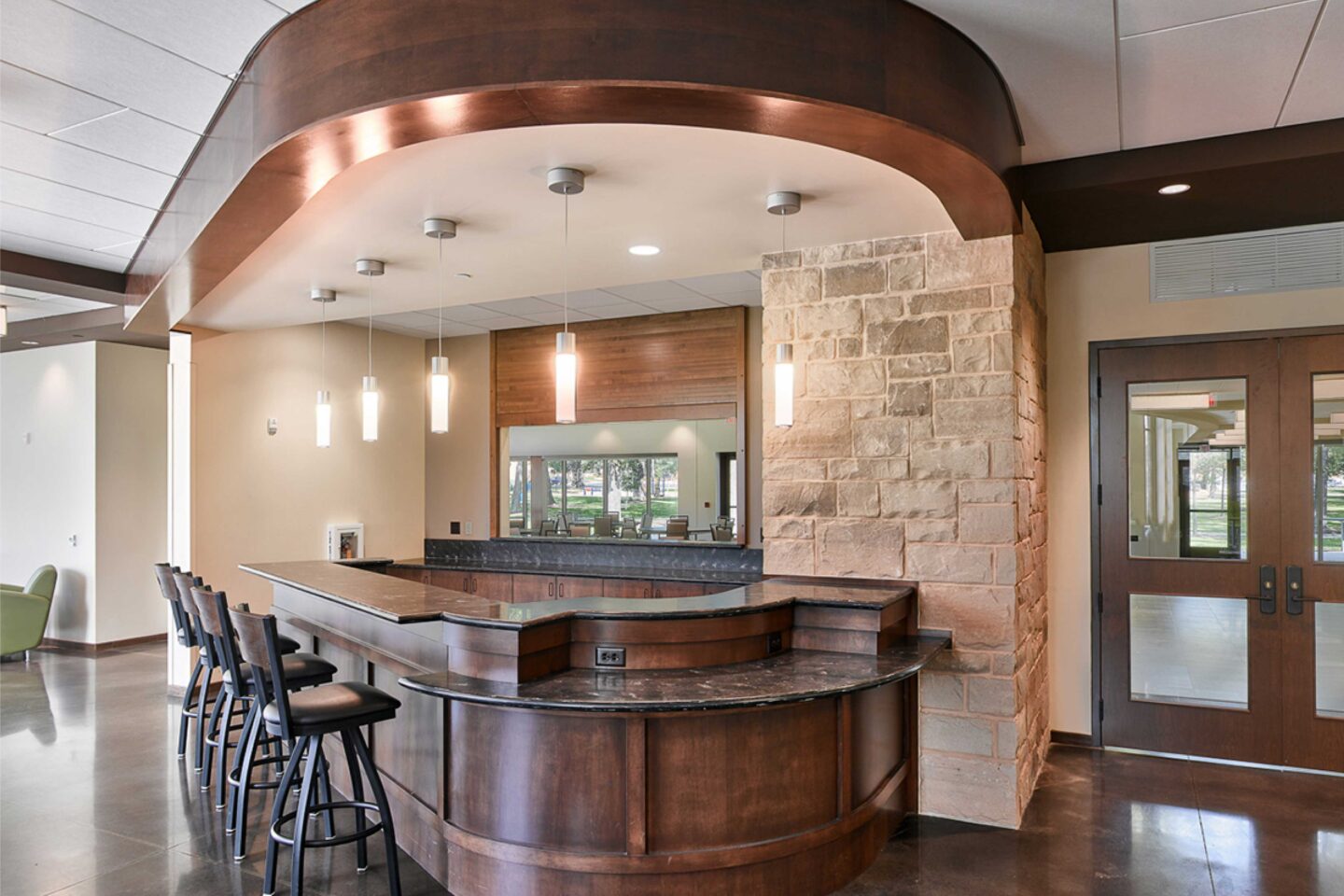 A bar area accented by wood and stone has contemporary and natural light