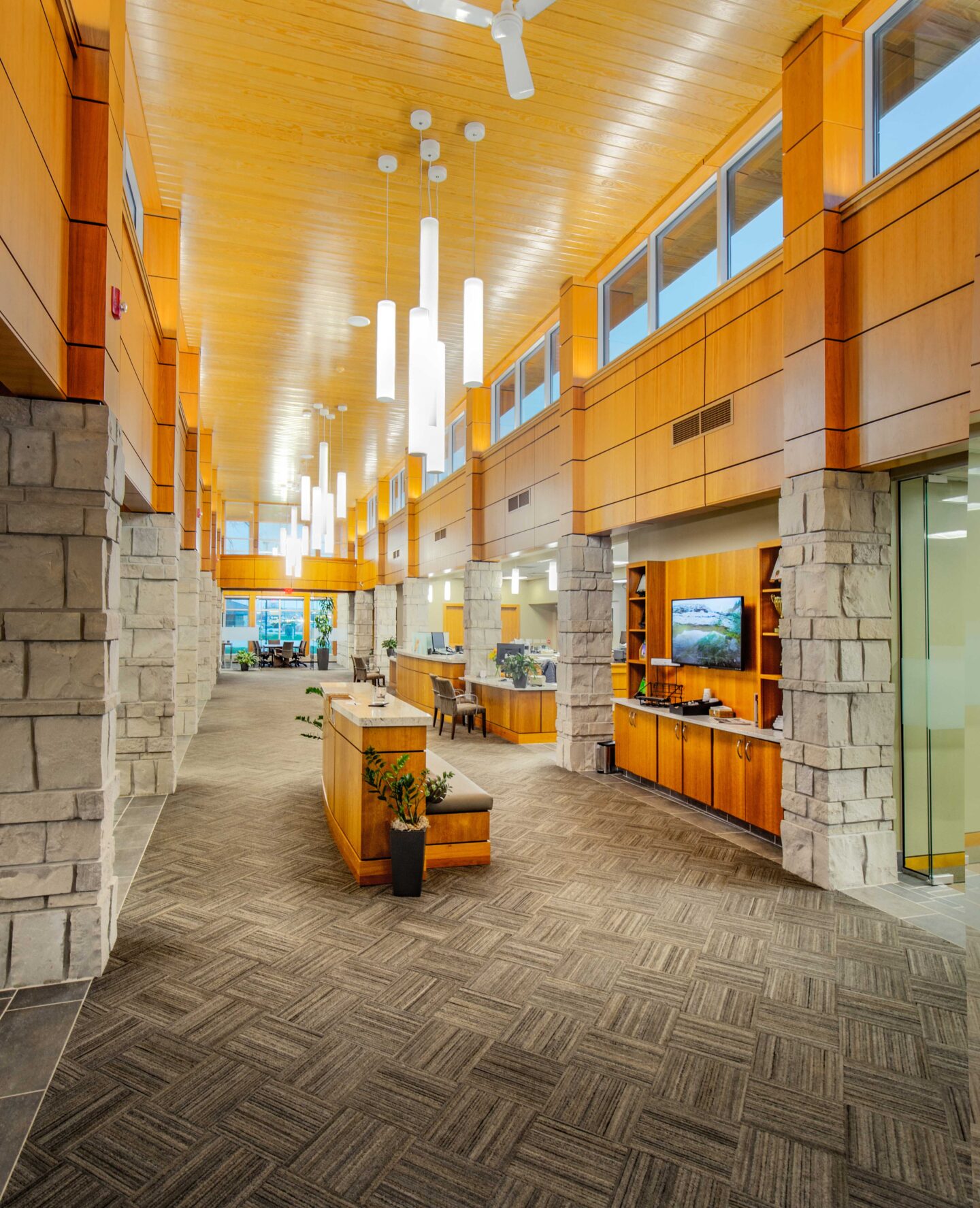 A bank interior with high ceilings and accents of stone and wood