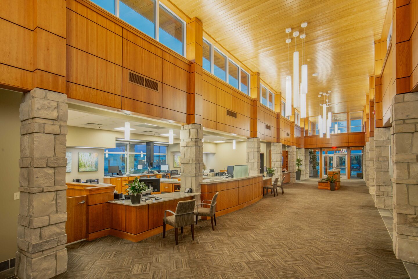 A bank interior with high ceilings and accents of stone and wood