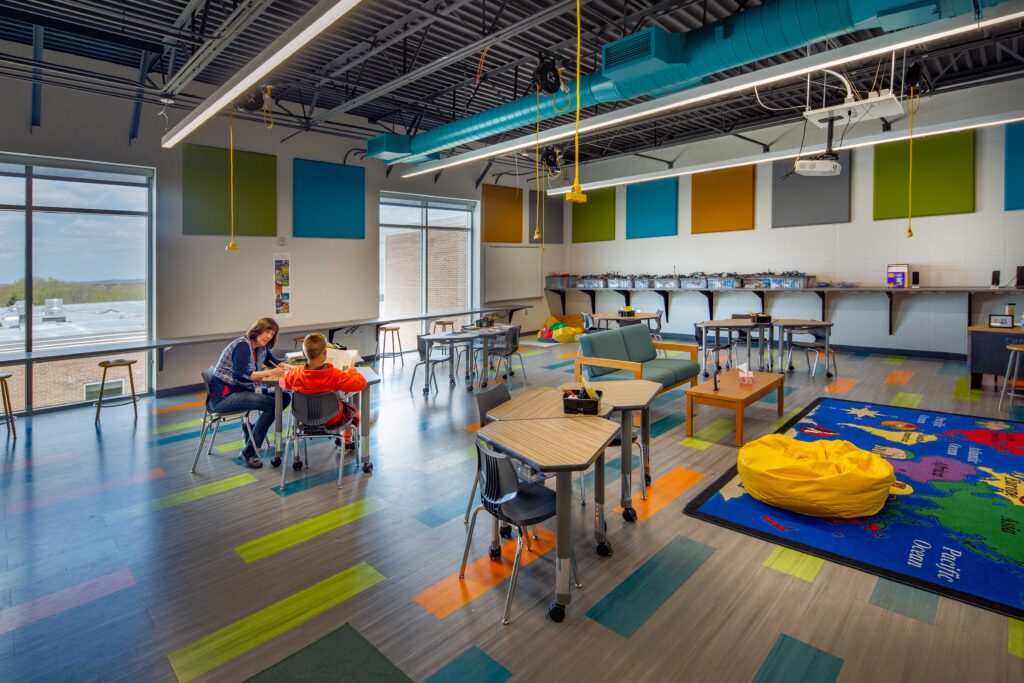 A colorful and windowed flex classroom has open spaces and flexible furniture at Belleville Intermediate School