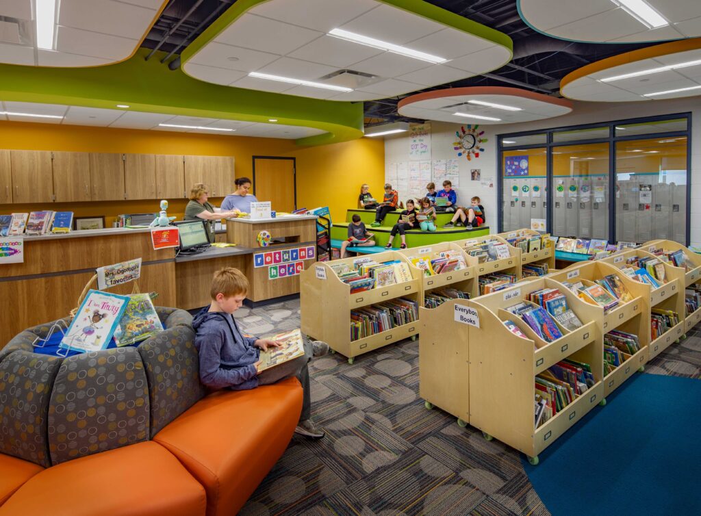 A cozy and colorful library space offers shelves and furniture designed for young learners at Belleville Intermediate School