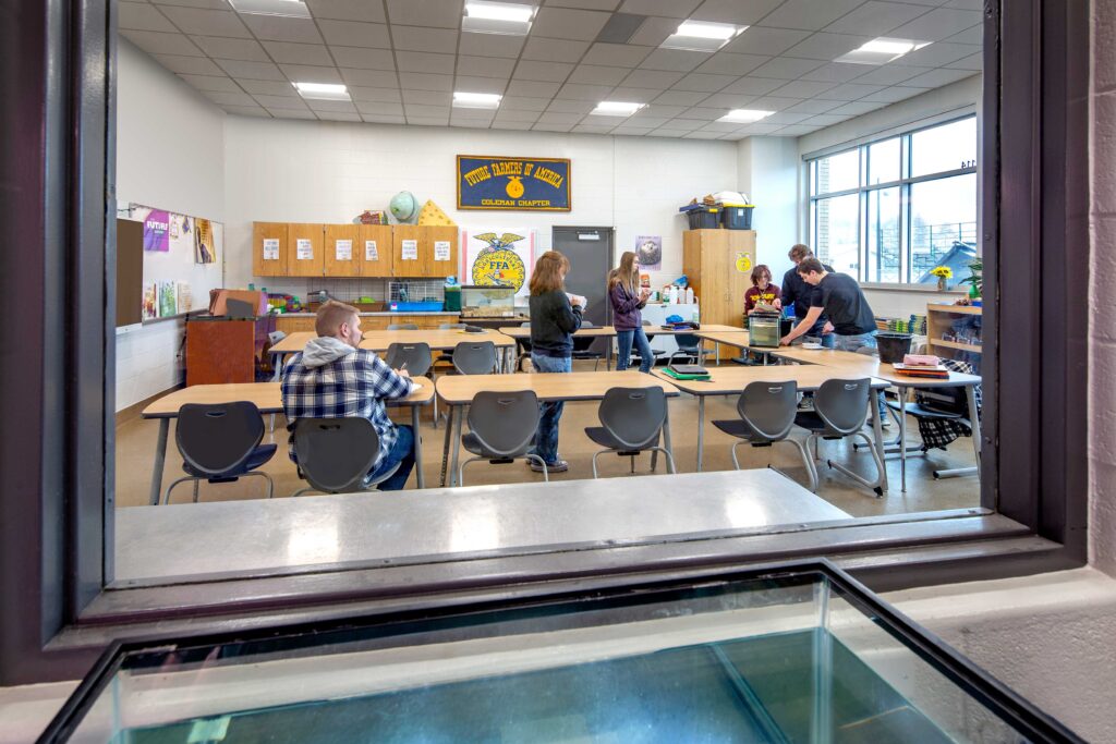 Storage and Future Farmers of America banners surround flexible work tables for students in an agriculture classroom at Coleman High School