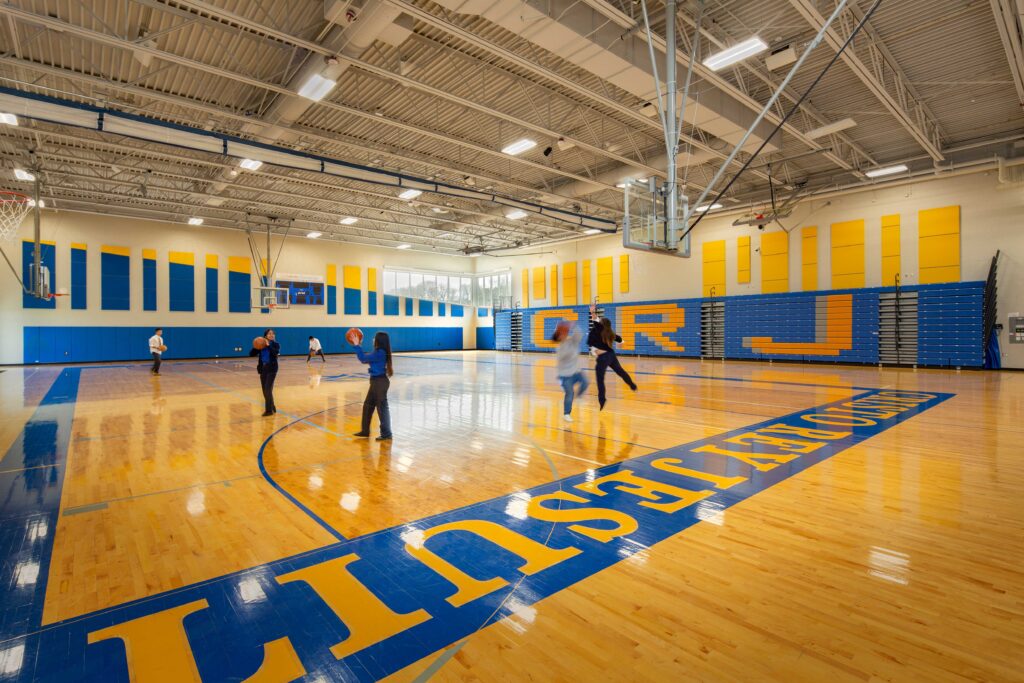 Gym with branding, featuring windows in the corner.