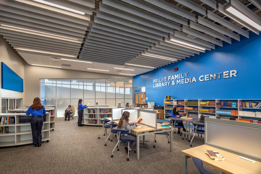 Library and media center featuring furniture and ceiling panels with lights.