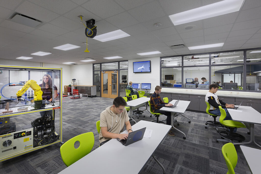 Students work on projects in the STEM lab, which includes windows to the adjacent classroom space