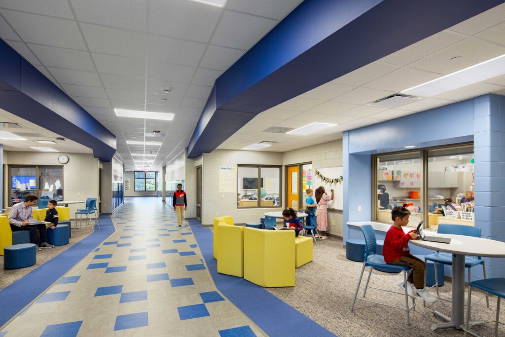 Students and teachers work in collaboration spaces created in between a hallway and classrooms at Green Bay's Eisenhower Elementary School