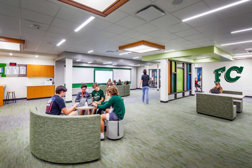 Students gather around flexible furniture in collaboration spaces connected to hallways at Fall Creek High School