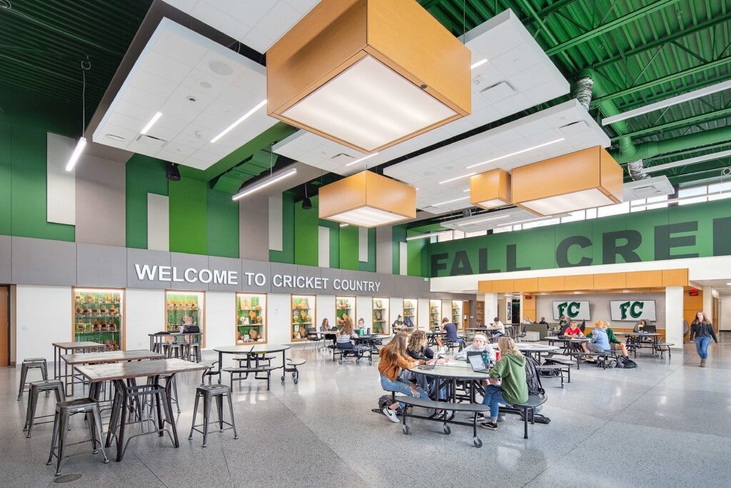 A wall of trophy cases enhances school spirit in a colorful, open commons area at Fall Creek High School