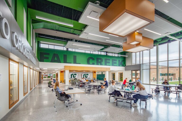 Large lettering work the school name into the colors and patterns of a bright, colorful commons area at Fall Creek High School