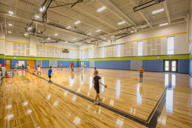 Kids play at a brightly lit, open gymnasium