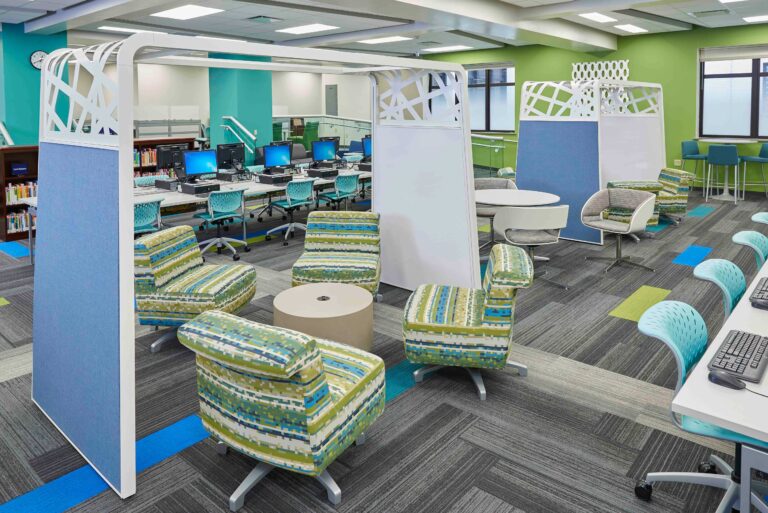 View of colorful furniture grouped into collaboration spaces in an updated library space