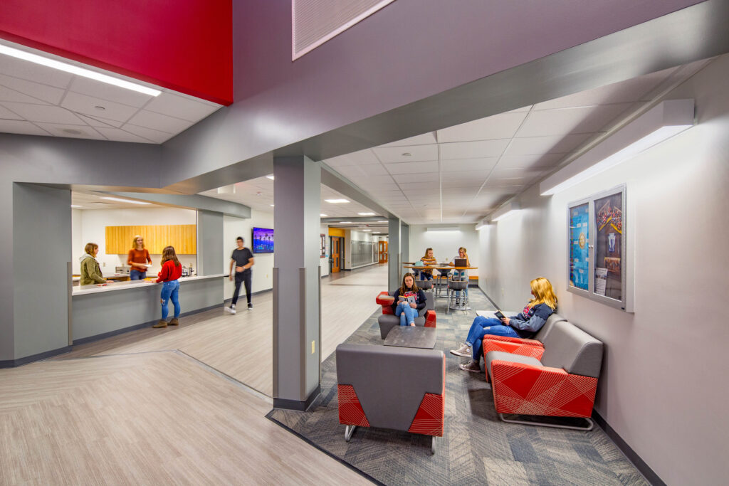 The concessions hallway featuring on a large concessions order window at the left and seating lounge at the right