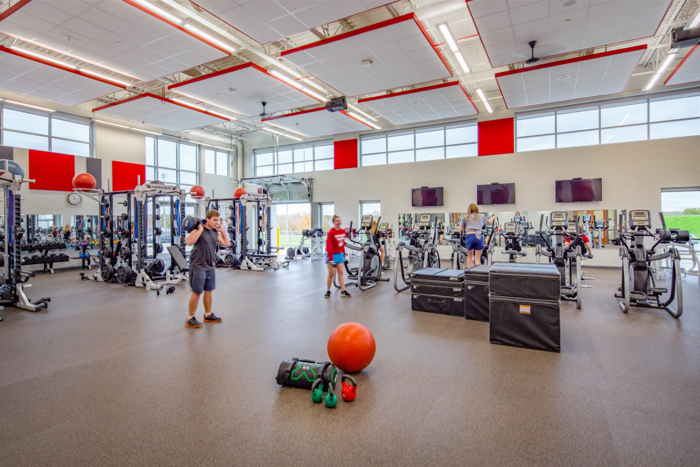 Student using weights and cardio equipment in the new fitness center