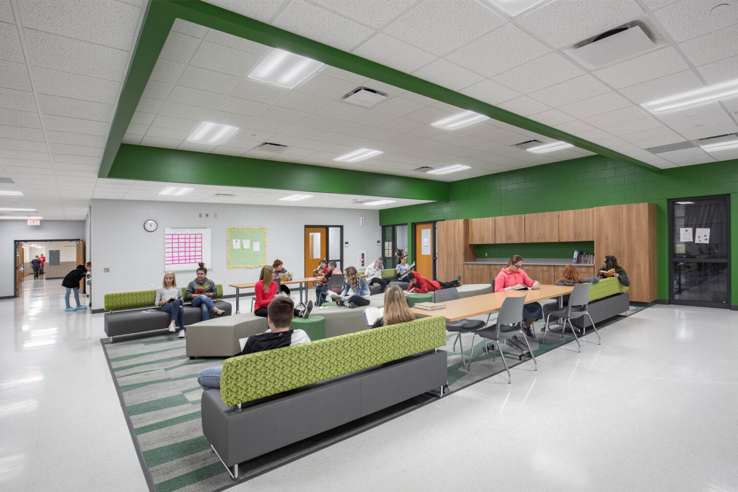 An open collaboration space adjacent to a hallway provides students a place for work and connection at Melrose-Mindoro School District