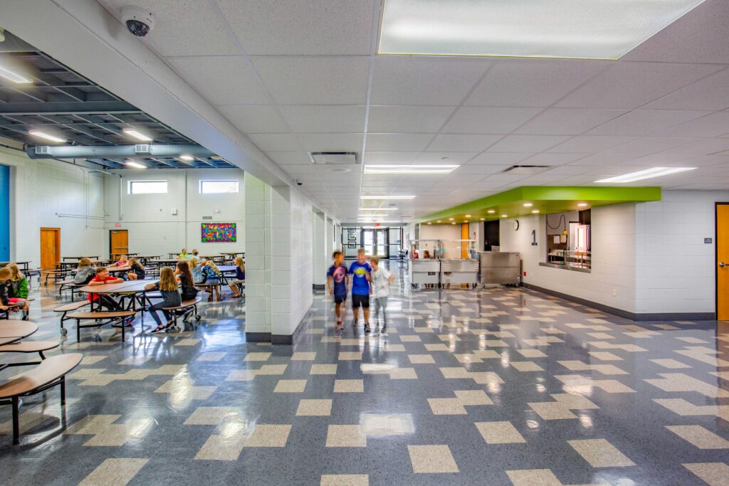 Students eat at tables in the former gymnasium, now a dedicated cafeteria