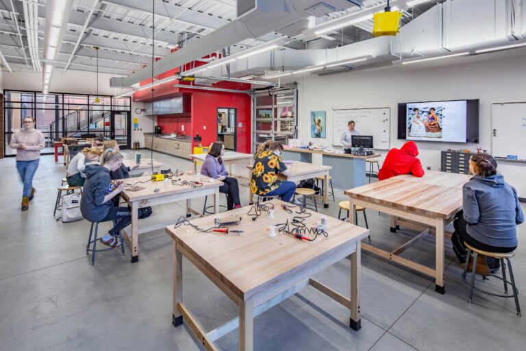 Students watch a demonstration in the 3D art room, which features an operable garage door to the adjacent classroom