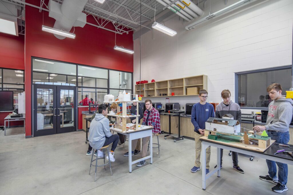 Students collaborate on projects in the fabrication lab, which has windows into adjacent classrooms spaces to make it easier for teachers to supervise multiple rooms