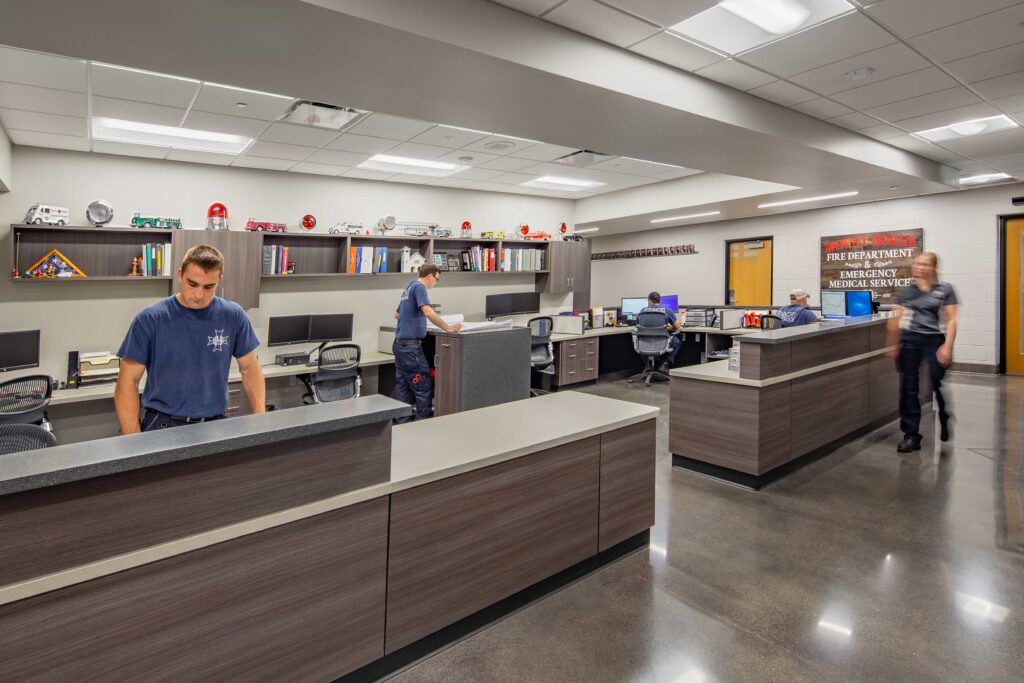 Public safety officers work in a workroom space lined with counters and shelves