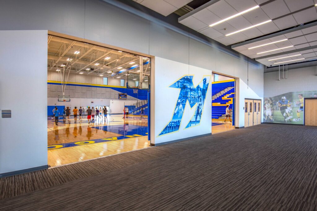 A photo collage in the shape of an M leads into a new gymnasium at Mukwonago High School