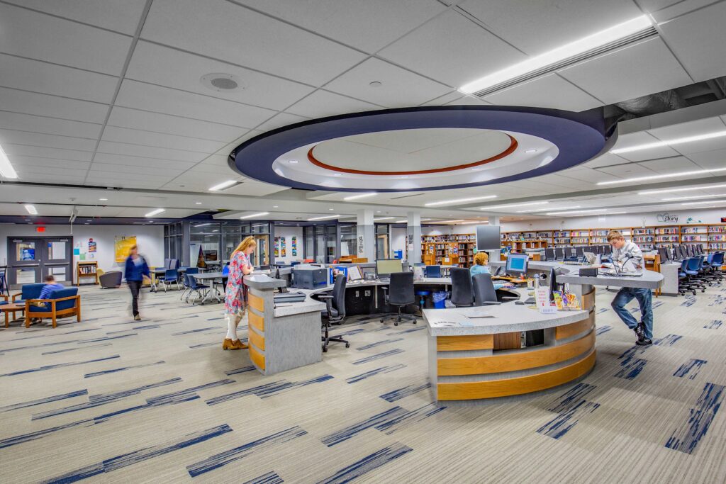 A circular information desk draws together an open work and library space at Mukwonago High School