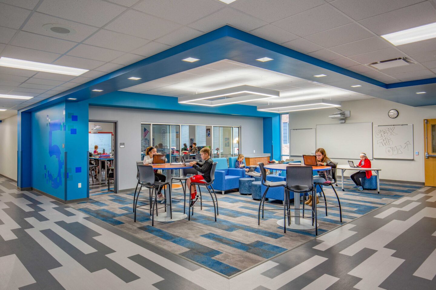 Students work independently in the "blue-themed" resource area