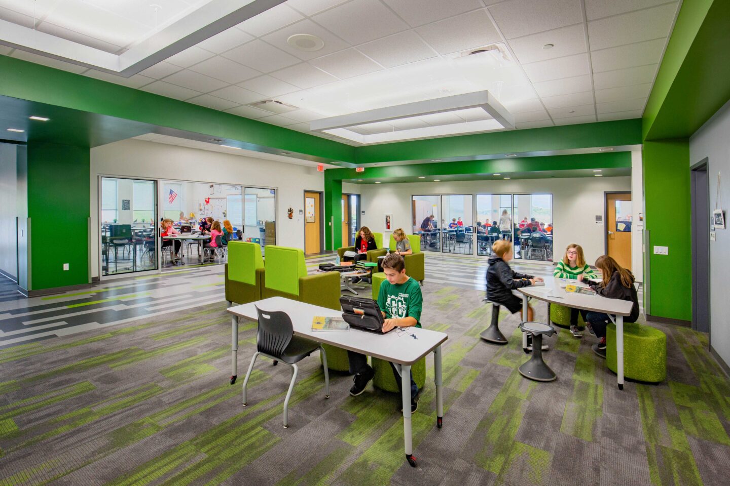 The "green-themed" resource area that serves several adjacent classrooms and is accessible through sliding glass doors