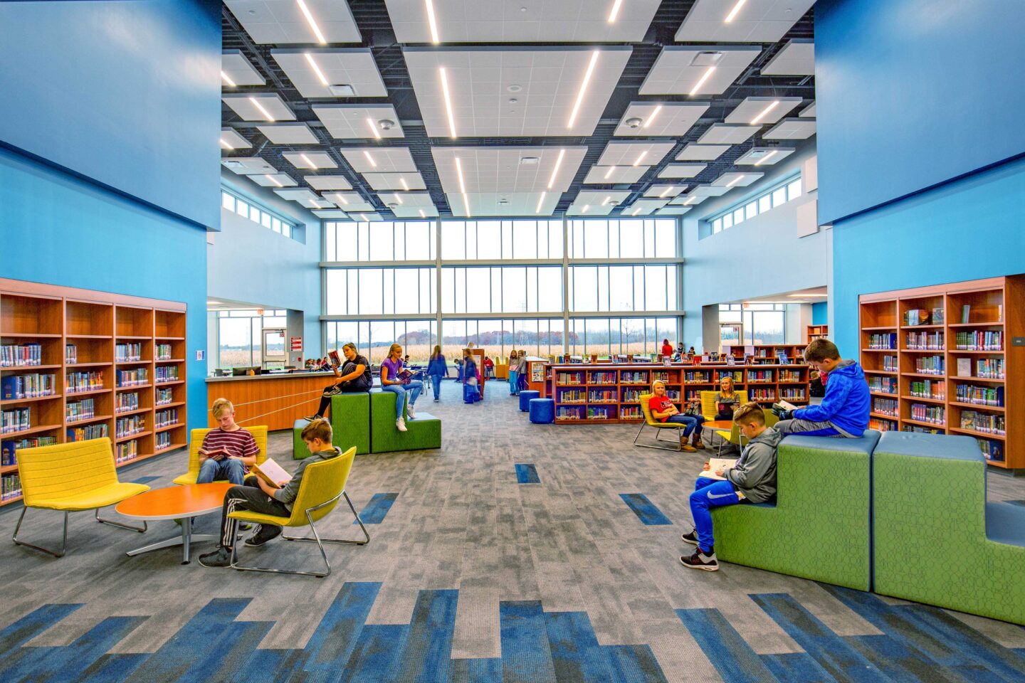 A view of the library anchored by the expansive floor-to-ceiling windows that allow abundant daylight into the space