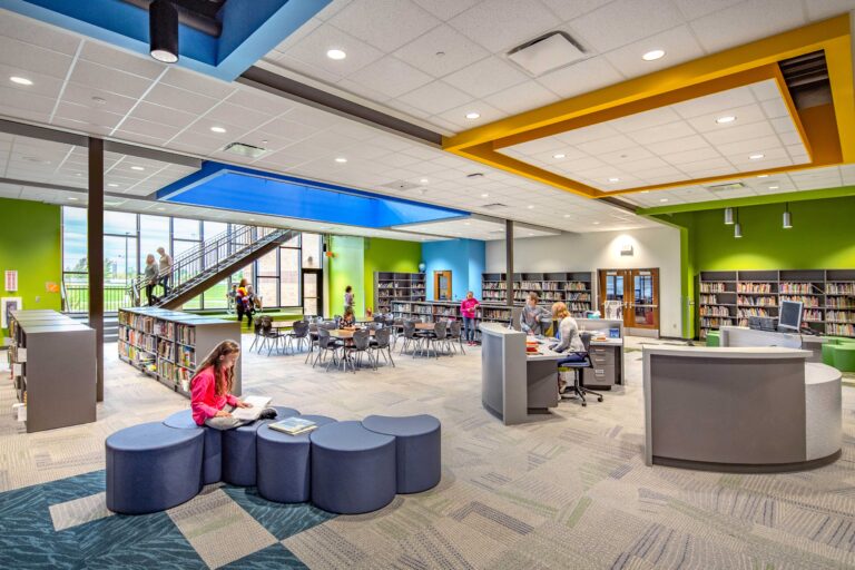 Students read in the new library, which features large windows and an an atrium that connects the lower and upper floors