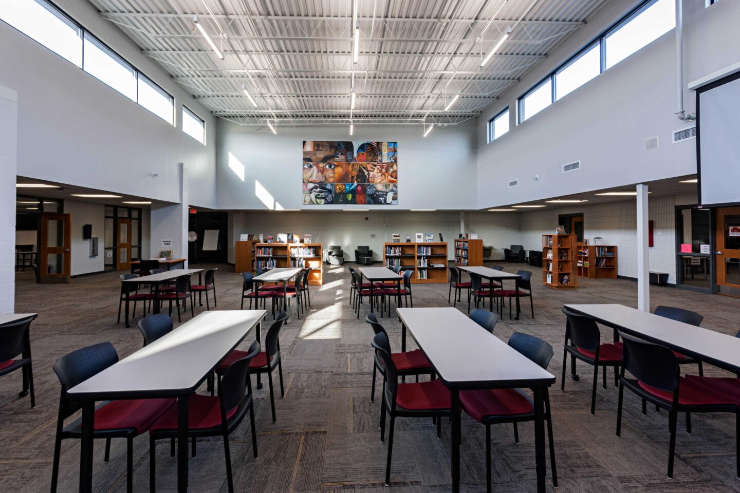 Rows of tables in the renovated library with a colorful mural of Martin Luther King Jr. in the background