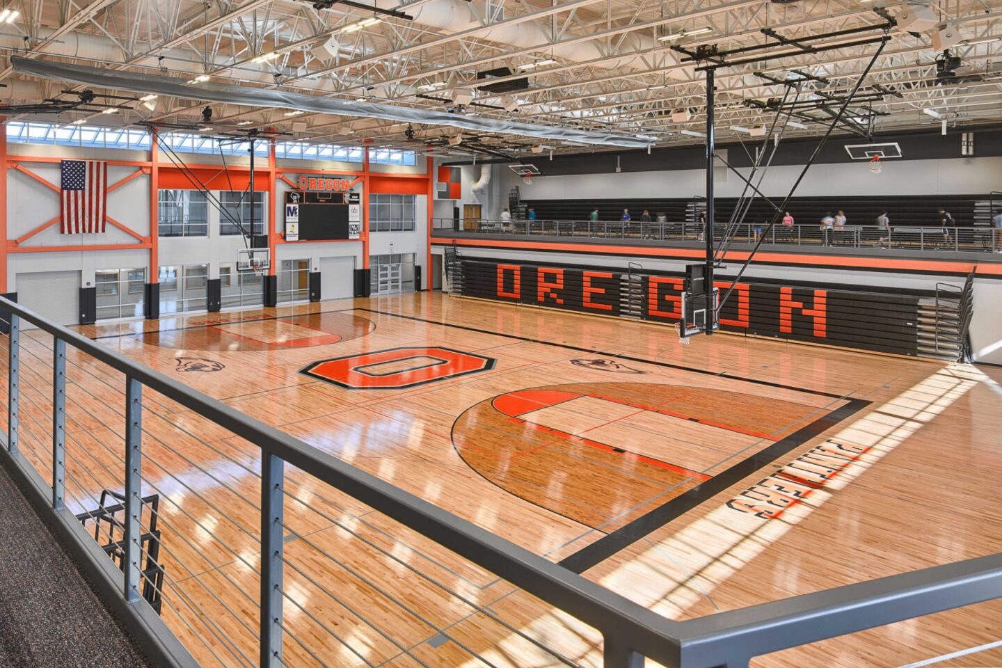 A view of the gymnasium featuring retractable bleachers and a mezzanine