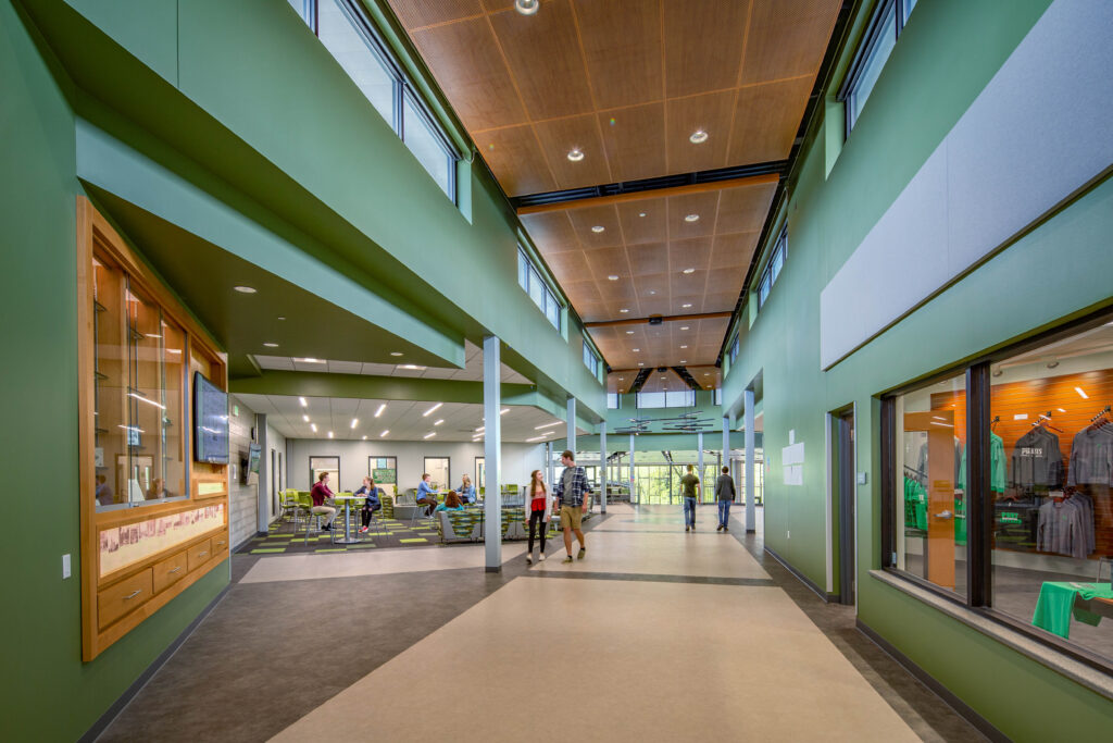 Front entry of Port Washington High School hallway with display case on the left side and sitting area in the far back