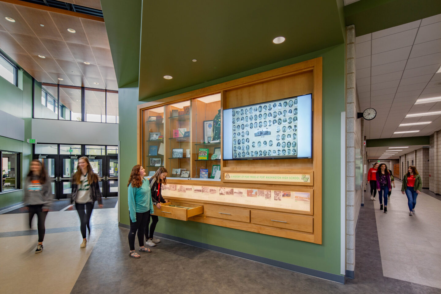 Students explore the historical display case at Port Washington High School.