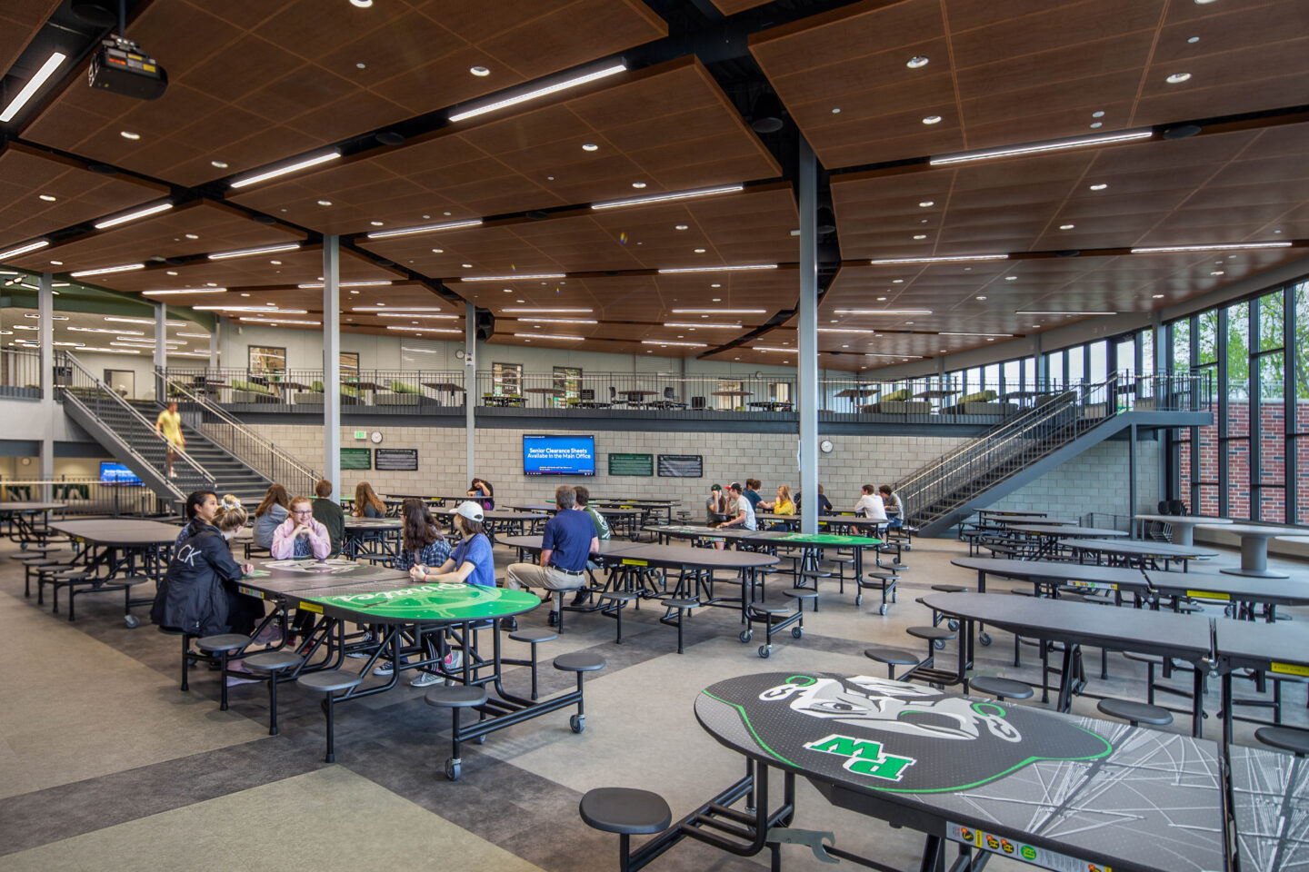 students sitting at tables in the lower cafeteria at Port Washington High School