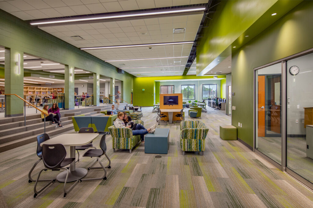 Port Washington high school students sitting in furniture in the lower floor instructional media center