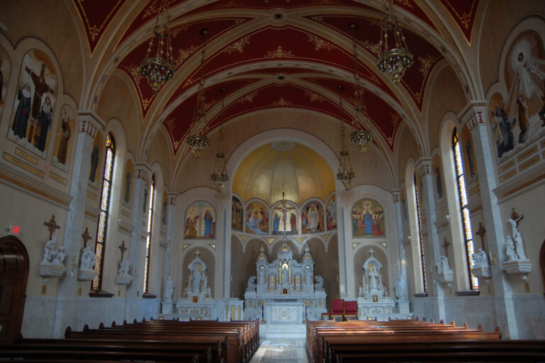 View of a soaring sanctuary filled with imagery and detail at Sacred Heart Catholic Church