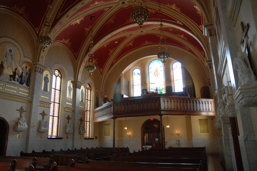 Light pours in from windows above a detailed and restored sanctuary