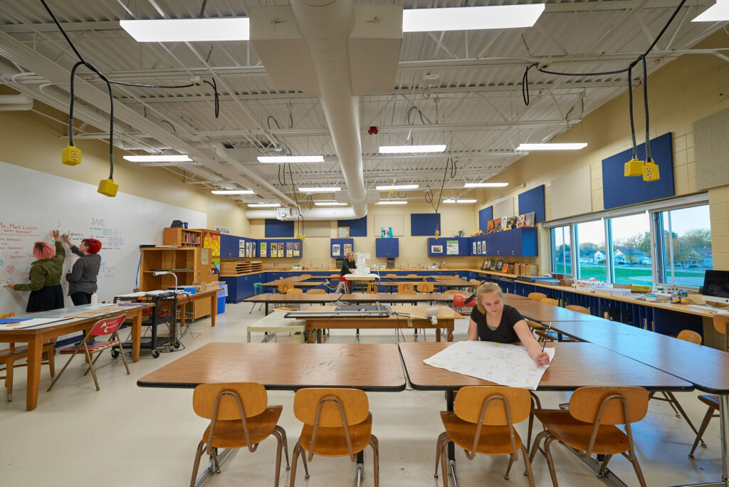 Tables for drafting and a wall covered with white boards provide collaboration and work space for students in the tech ed updates at Sheboygan North High School