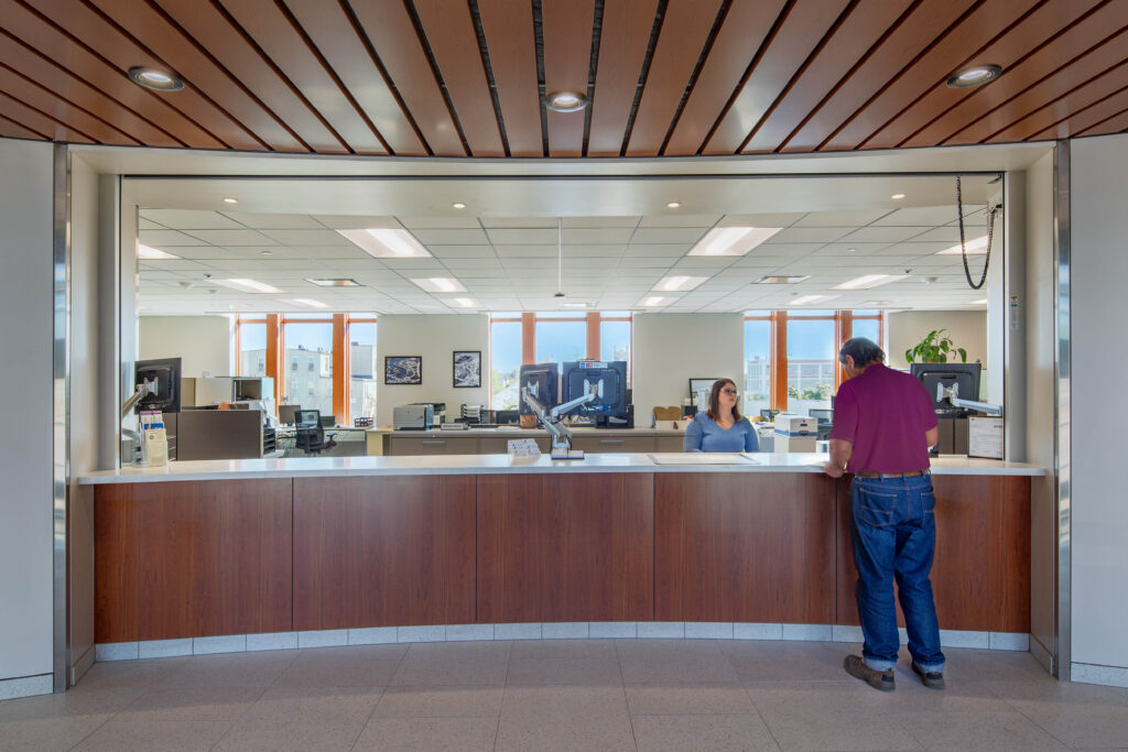 A person stands at an approachable counter for city services at Sheboygan City Hall