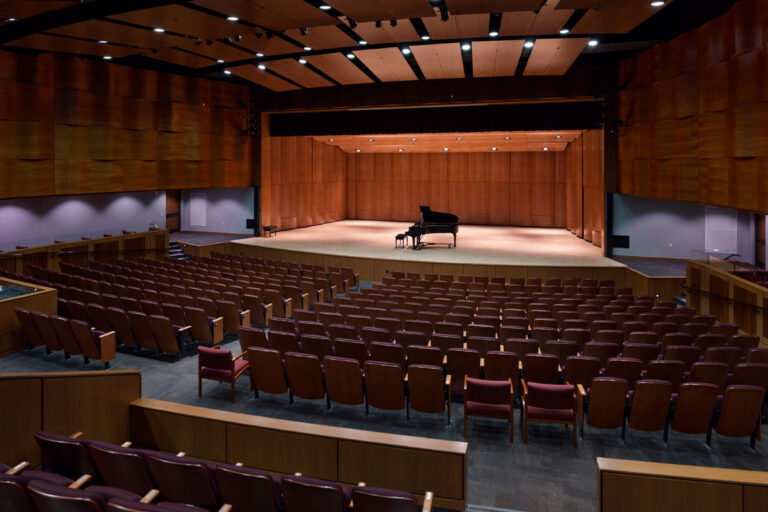 View from the back of a large, wood-paneled concert hall