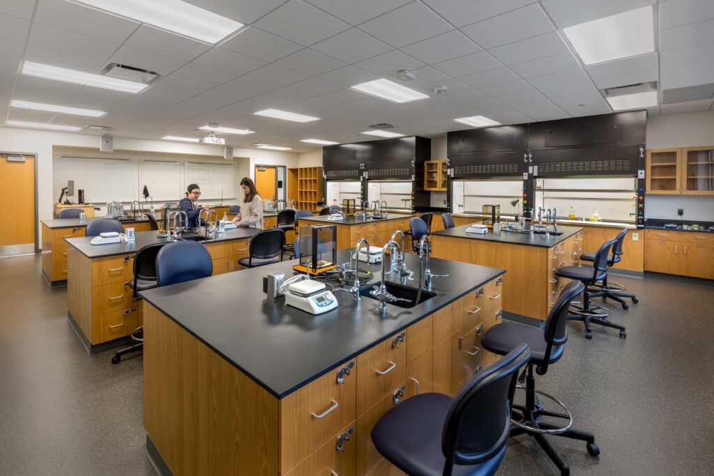 Students work at a cluster of lab tables in a classroom